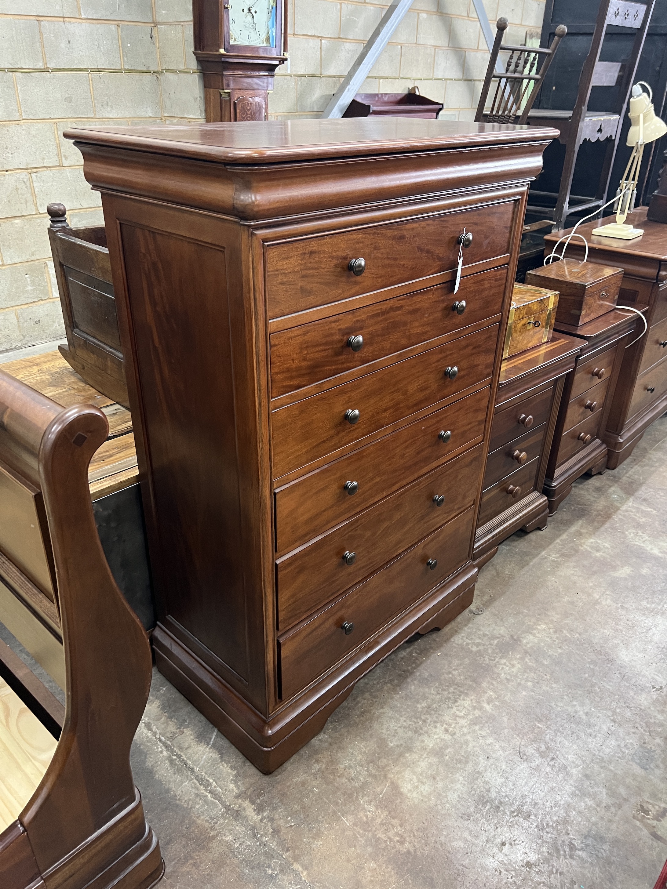 A contemporary five piece French mahogany bedroom suite, comprising sleigh bed, width 190cm, length 220cm, height 102cm (missing some bolts), a six drawer tall chest, three drawer chest and a pair of bedside chests